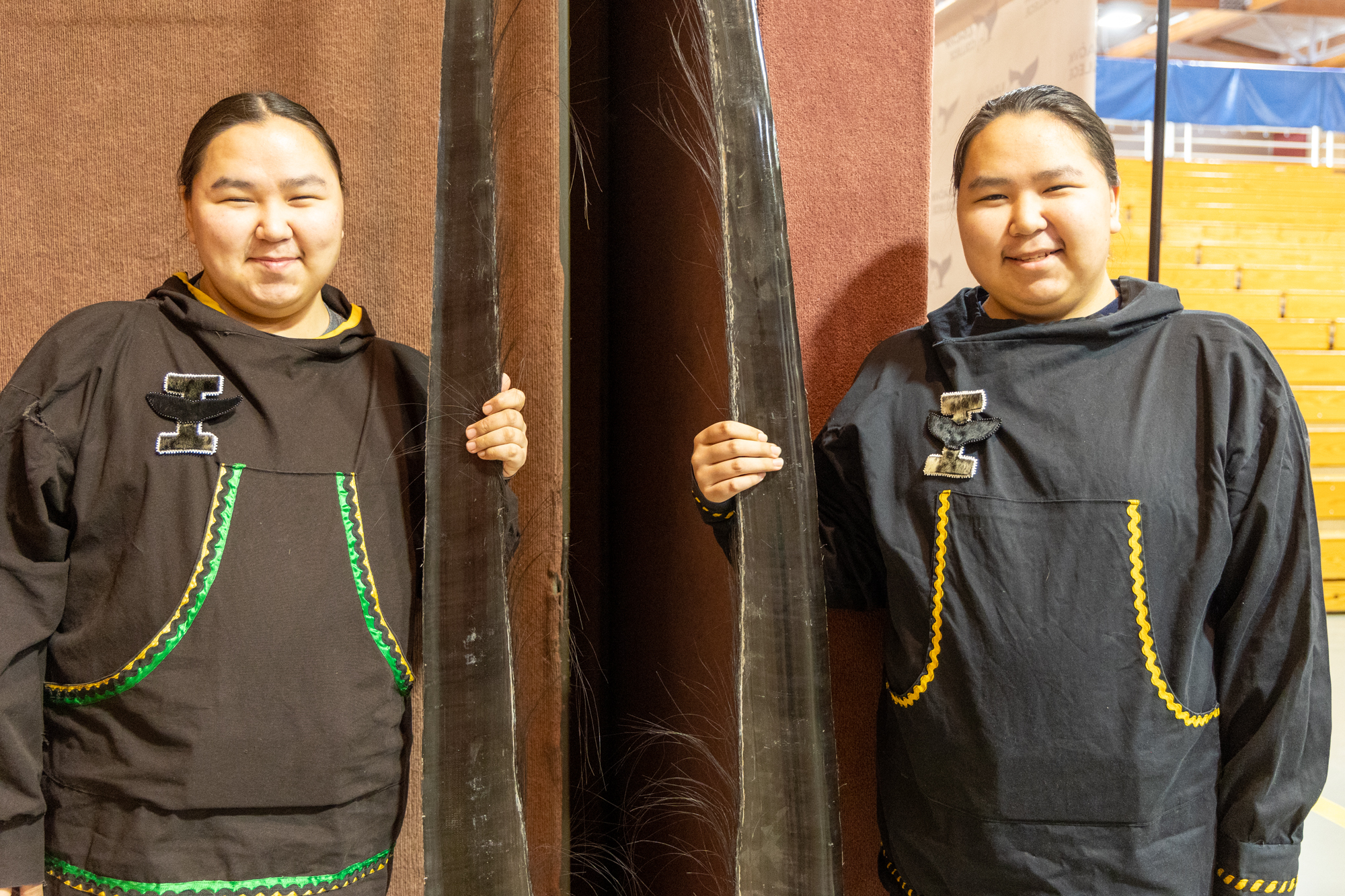 students hold baleen at graduation